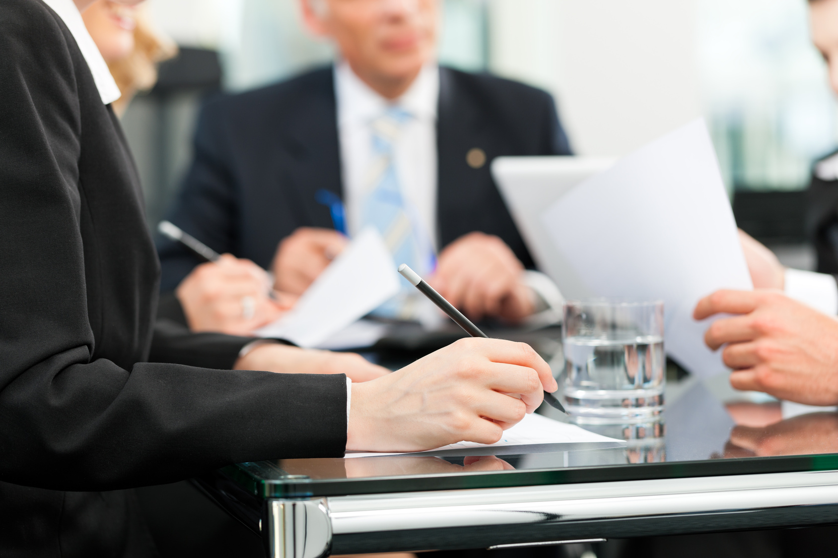 Business - meeting in an office, lawyers or attorneys discussing a document or contract agreement